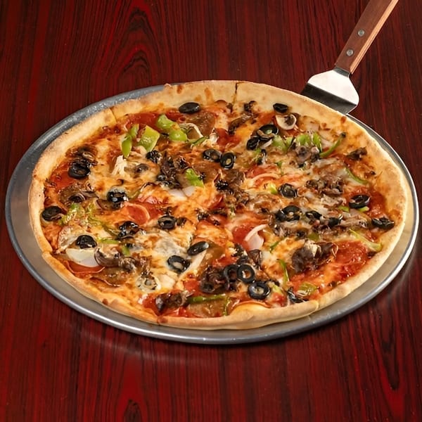 A whole supreme pizza with pepperoni, olives, mushrooms, and peppers on a metal pan.
